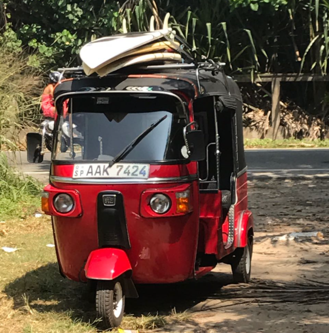 surf boards on a tuk tuk