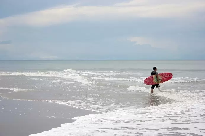 Surfer getting into the water