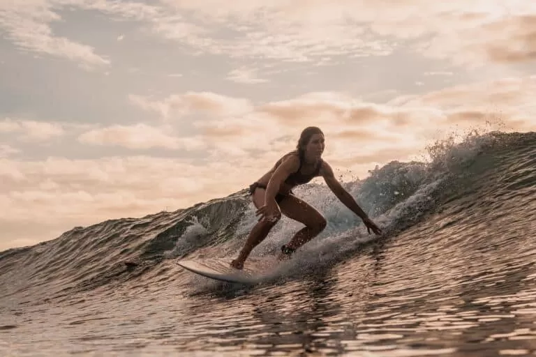 Woman Surfing In the Mentawai Islands